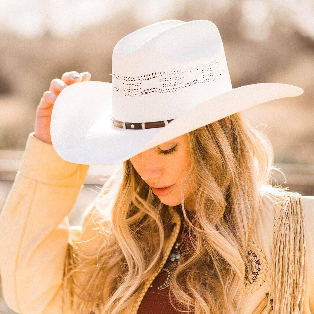 A woman wearing Billings Cream Straw Cowboy Hat on an angle side