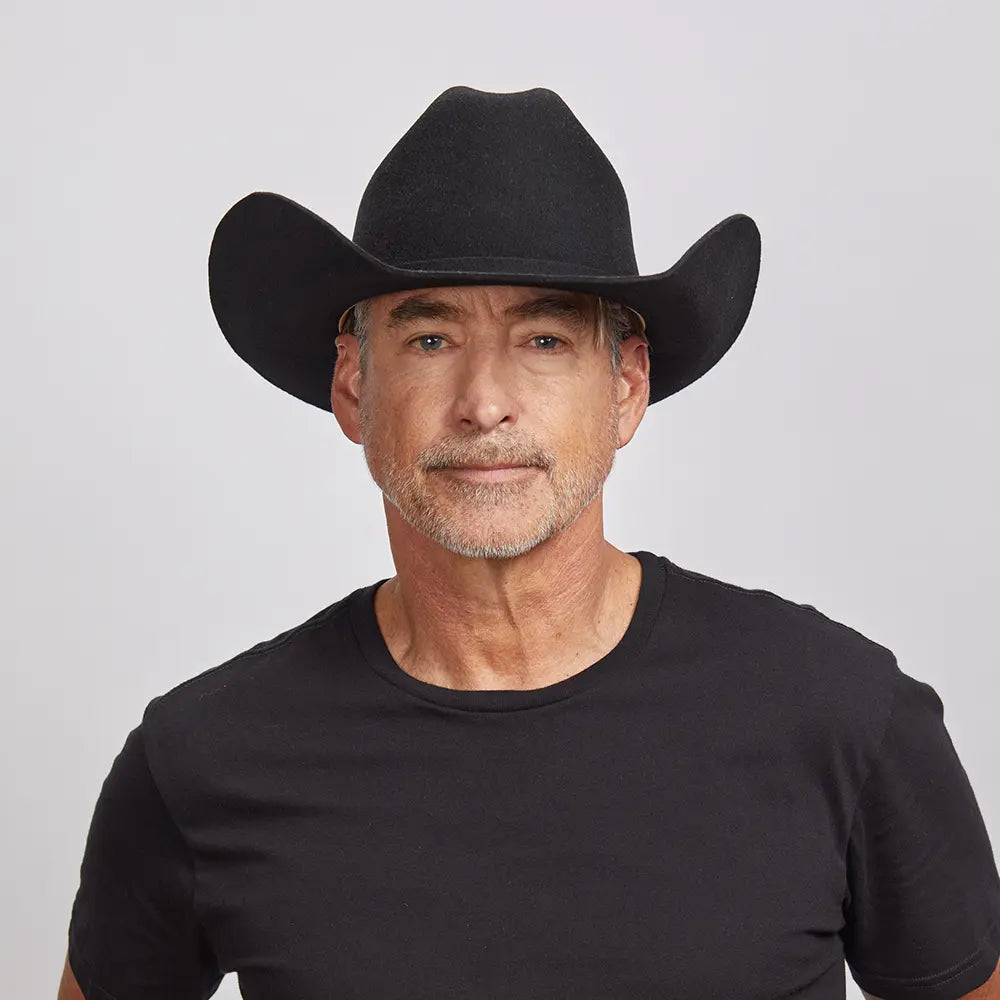 model wearing black cattleman cowboy hat