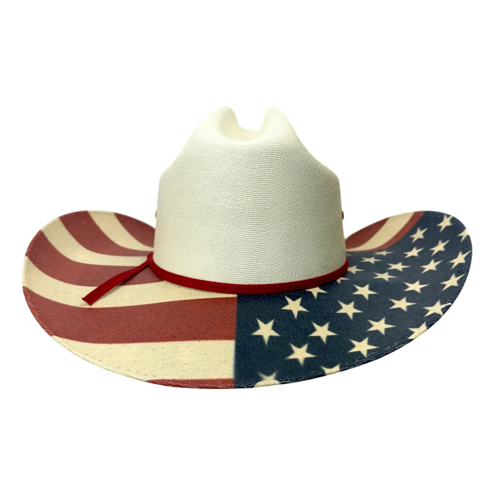 A cowboy hat with a white crown and a brim printed with an American flag pattern, featuring red and white stripes on one side and white stars on a blue background on the other, with a red band and bow.