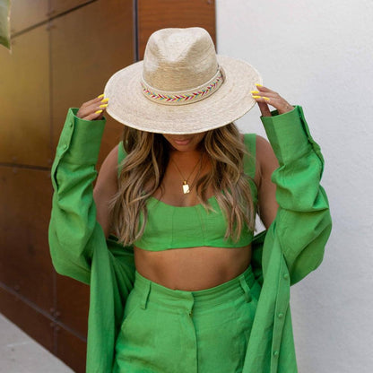 A man in a green outfit wearing Bisbee Straw Hat with Colorful Hat Band