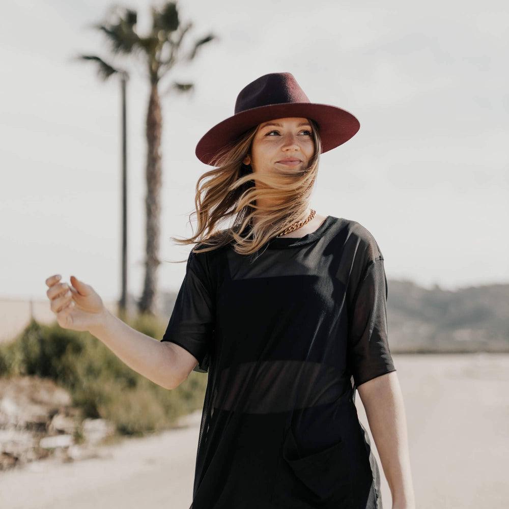 A woman wearing Bordeaux Plum Wide Brim Felt Fedora 