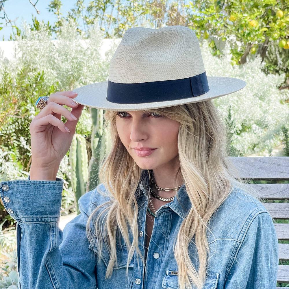 A woman wearing Panama Fedora in a side view