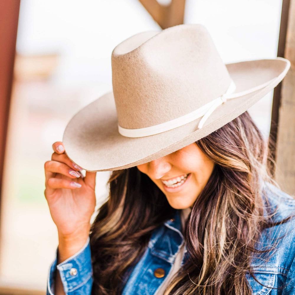 A woman on a side view wearing Crescent Oatmeal Felt Wool Fedora Hat