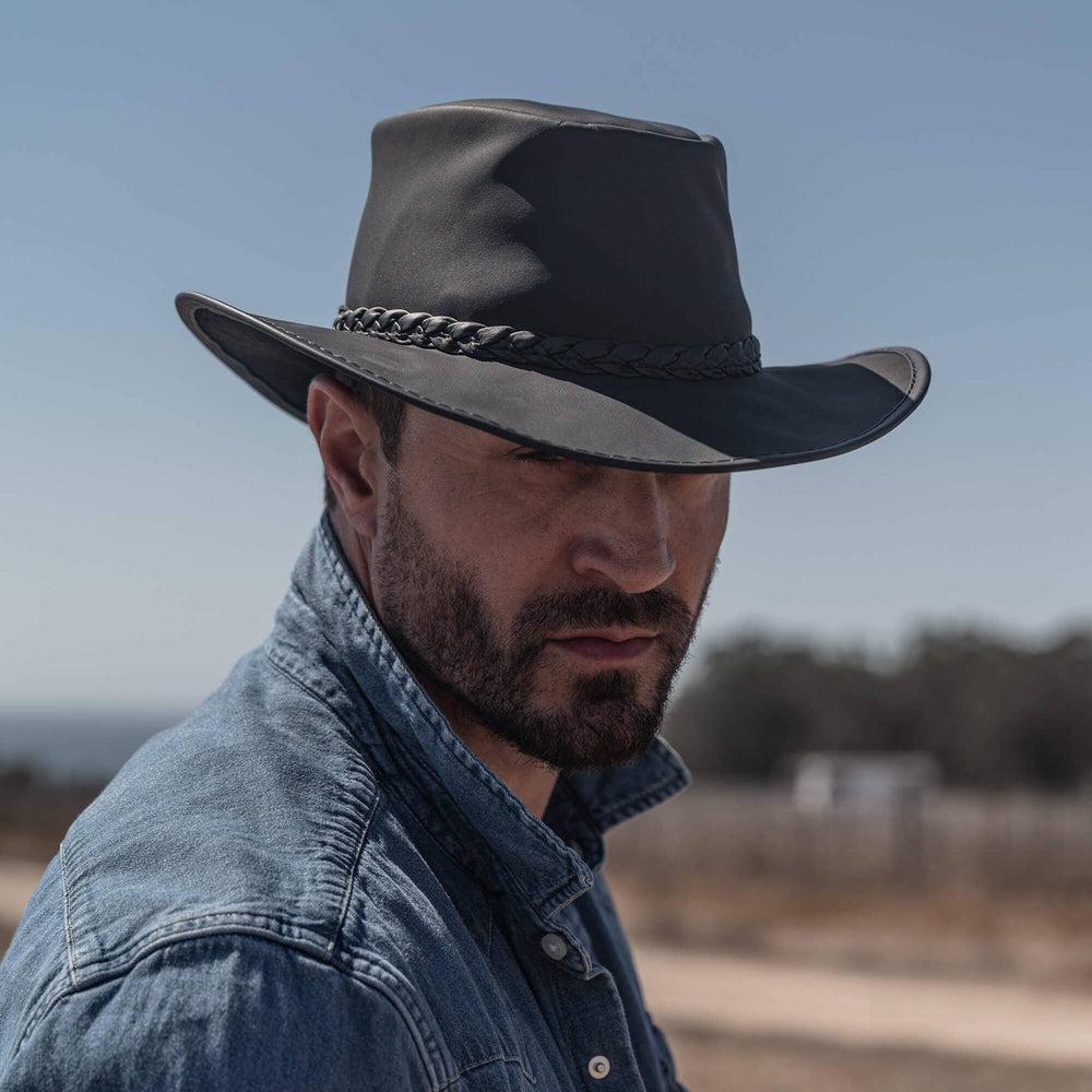 A man with a denim jacket and an Outback Leather Hat 