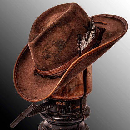 An angled view of a Duke Brown Felt Cowboy Hat placed on a stand