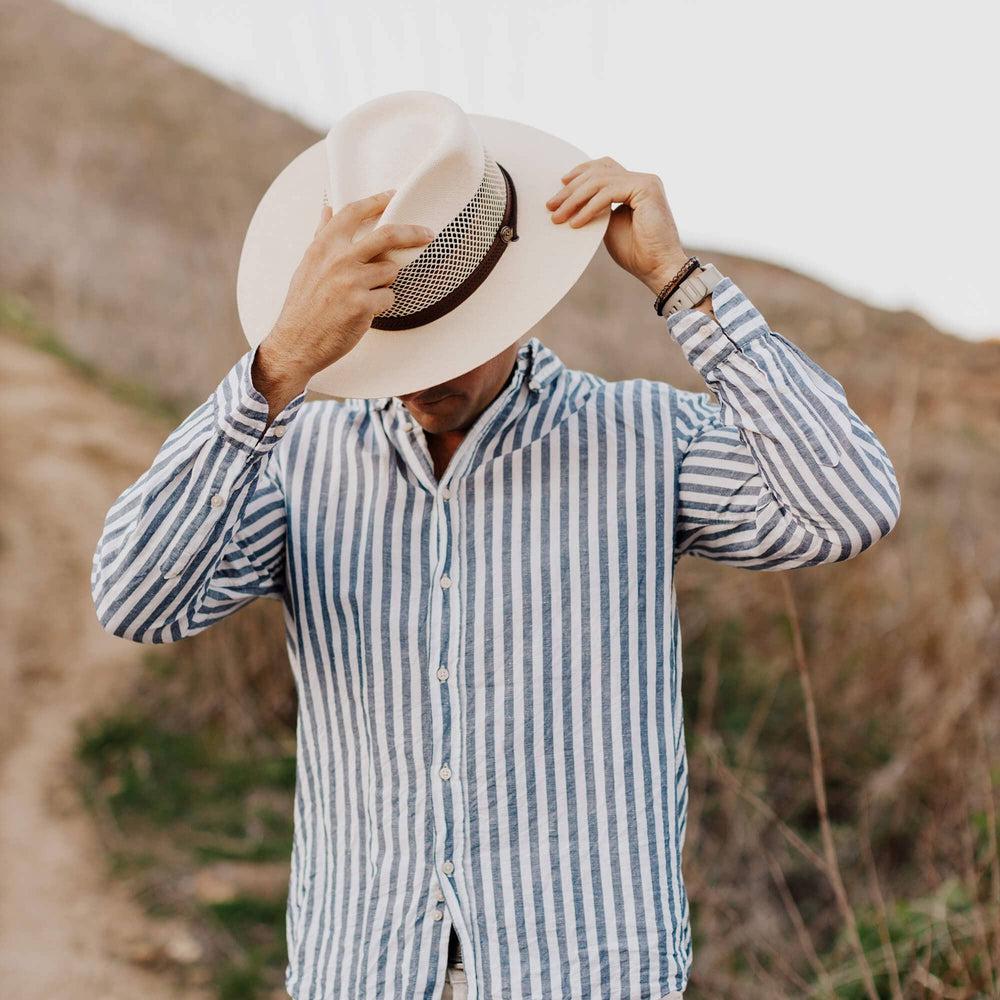 A man wearing stripes and a Florence Cream Straw Sun Hat