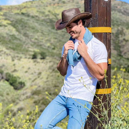 A man leaning on a post wearing Hollywood Brown Leather Cowboy Hat 