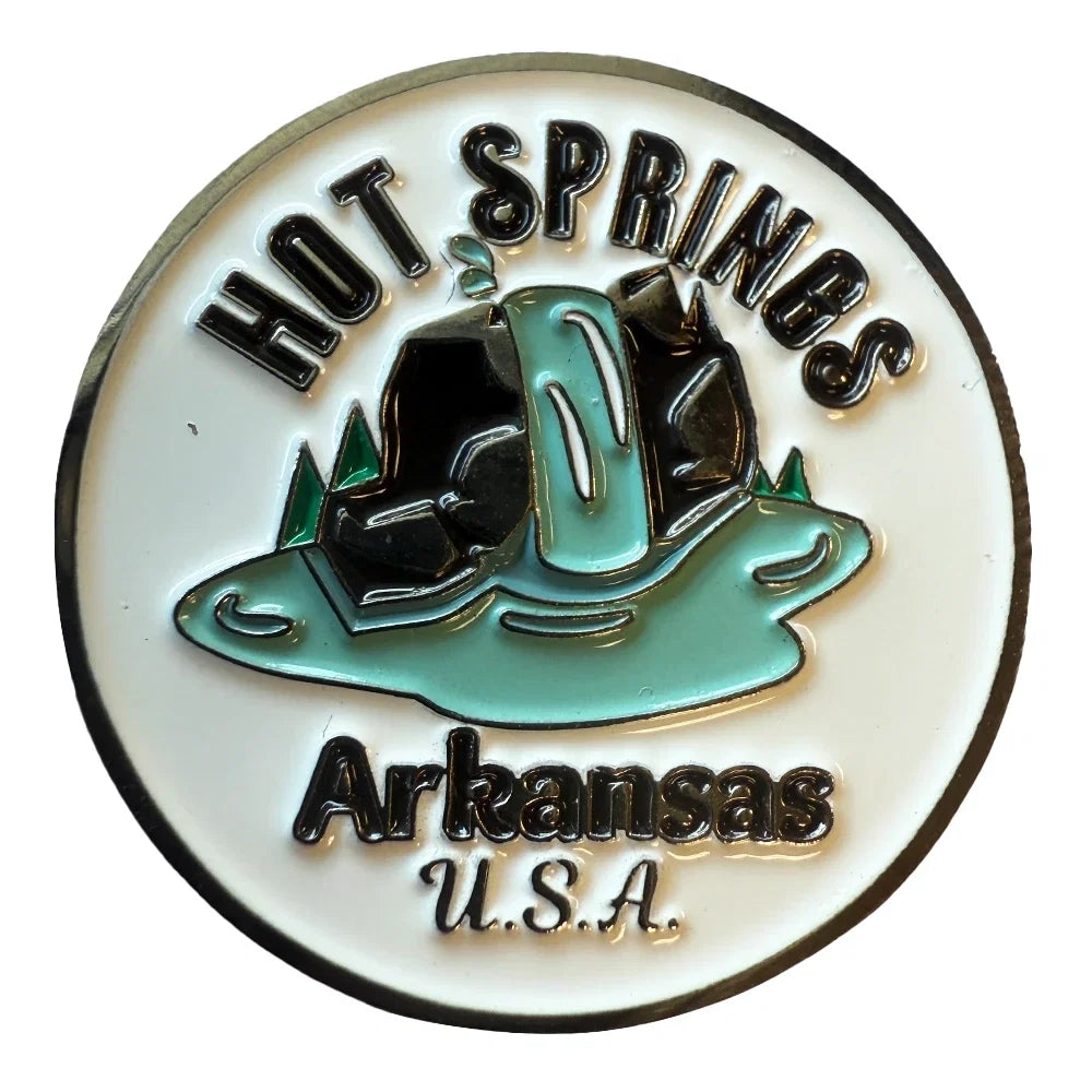 A circular enamel pin featuring a white background with a metallic silver border, the words 'HOT SPRINGS' at the top and 'Arkansas U.S.