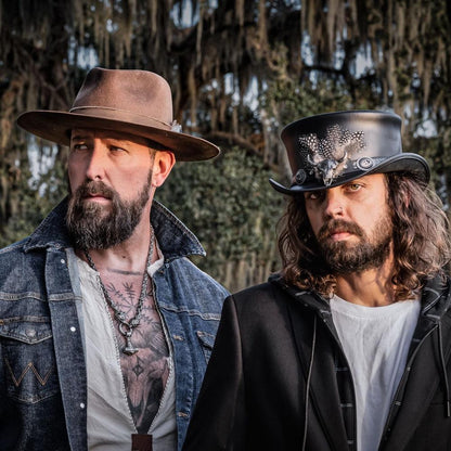 Two men wearing different kinds of hat outdoors