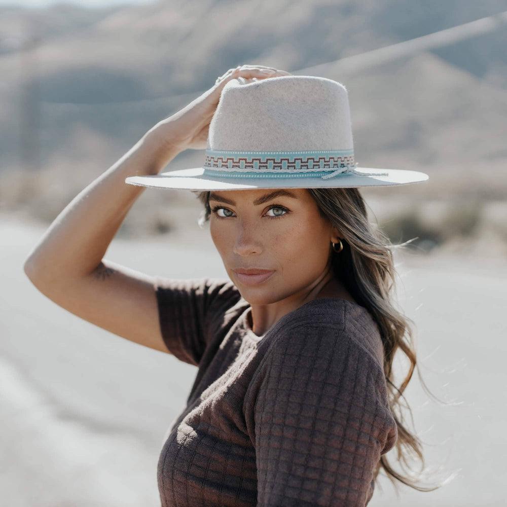 A woman wearing Wide Brim Felt Fedora hat