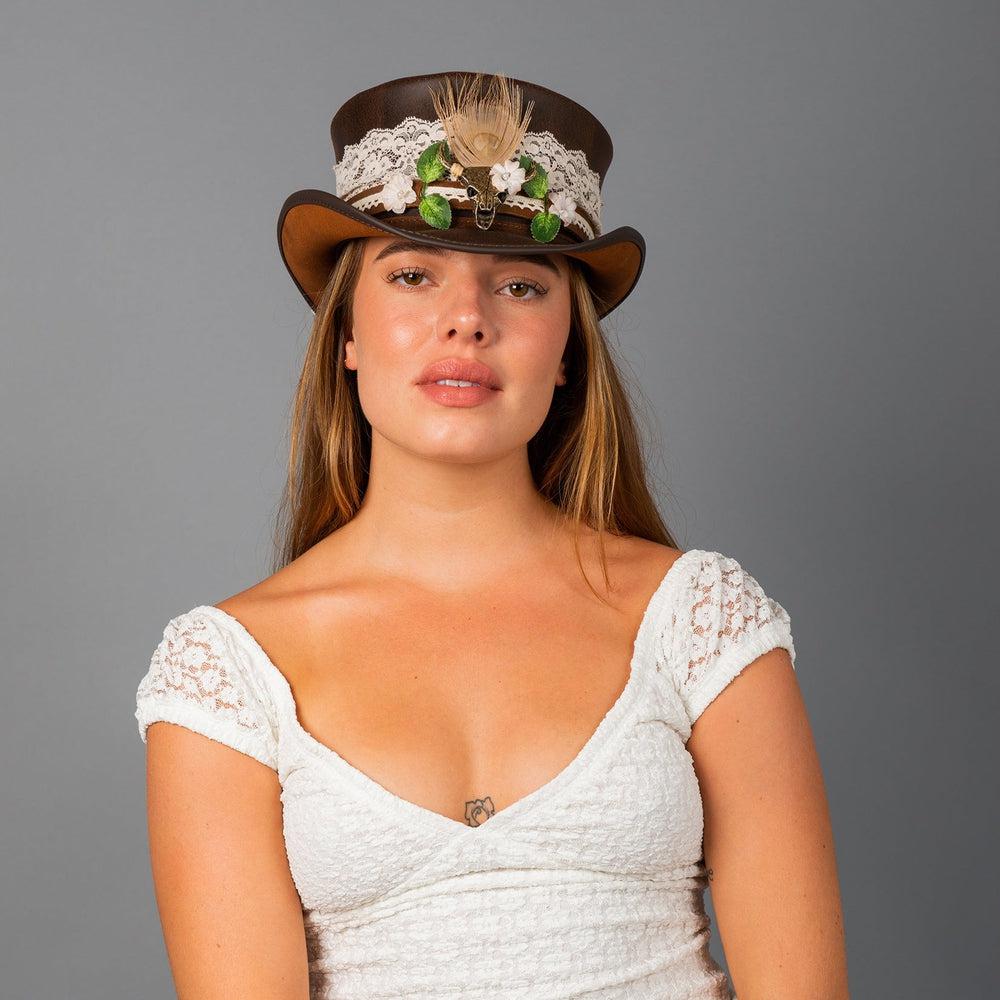 A woman wearing a white dress and a top hat with true love beaded hat band