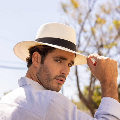 A man wearing White Panama Fedora Hat 