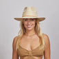 Portrait of a smiling woman with blonde hair wearing a Paulo straw hat and a brown knitted top.