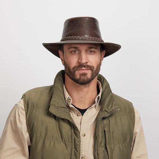 Man with a light stubble wearing a Chocolate Roughneck Outback Hat and an olive green jacket over a beige shirt