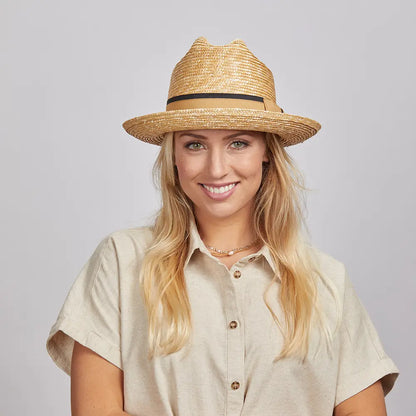 Woman with blonde hair wearing a Sawyer Straw Hat and a beige shirt.