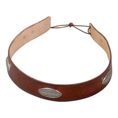 A brown leather headband with three silver concho-style metal studs and a tan interior lining, shown on a plain white background.