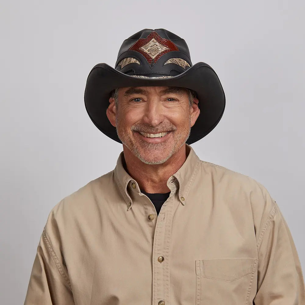 An older man wearing a Black Storm Cowboy Hat, posing in a light khaki shirt.