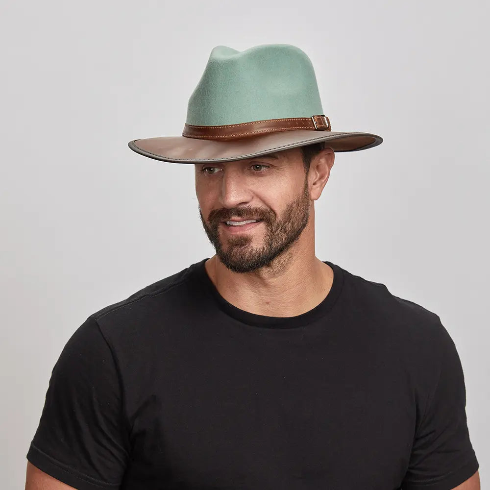 A man wearing the Summit Sage Felt Leather Fedora Hat, looking slightly to the side.