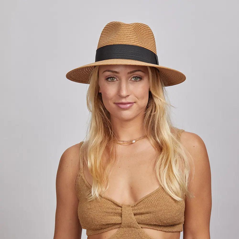 A blonde woman wearing a Beige Afternoon Fedora Hat and a brown knitted top.