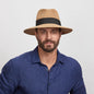 Man wearing a Beige Afternoon Sun Hat and a blue shirt