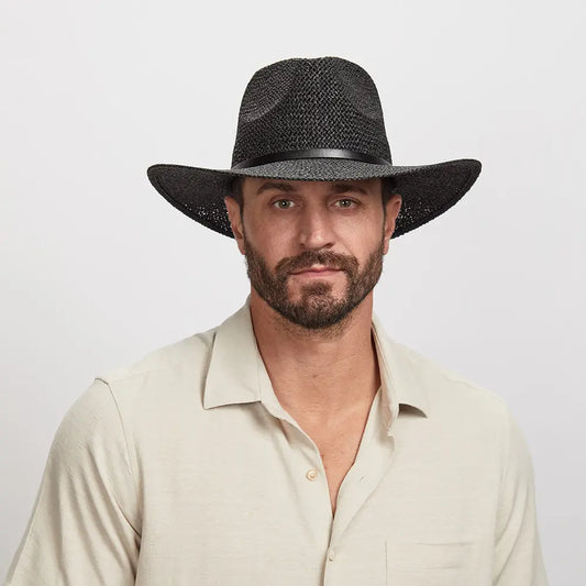 Man wearing a Titus Sun Hat and a light beige button-down shirt