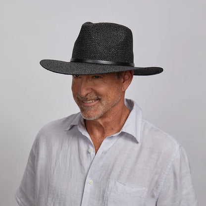 Man wearing a Titus Sun Hat and a light gray button-down shirt.