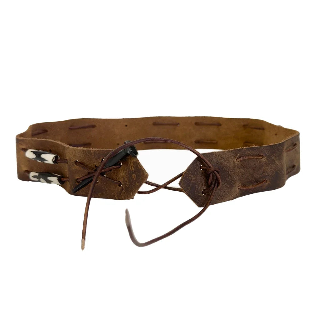A rustic brown leather belt with a double strap design, featuring a black leather tie, a silver-toned metal hook, and two white beads with black detailing on the left side, set against a plain white background.