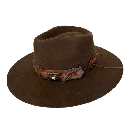 A dark brown felt cowboy hat with a matching brown leather band featuring silver-toned conchos and a small blue feather accent, shown on a plain white background.