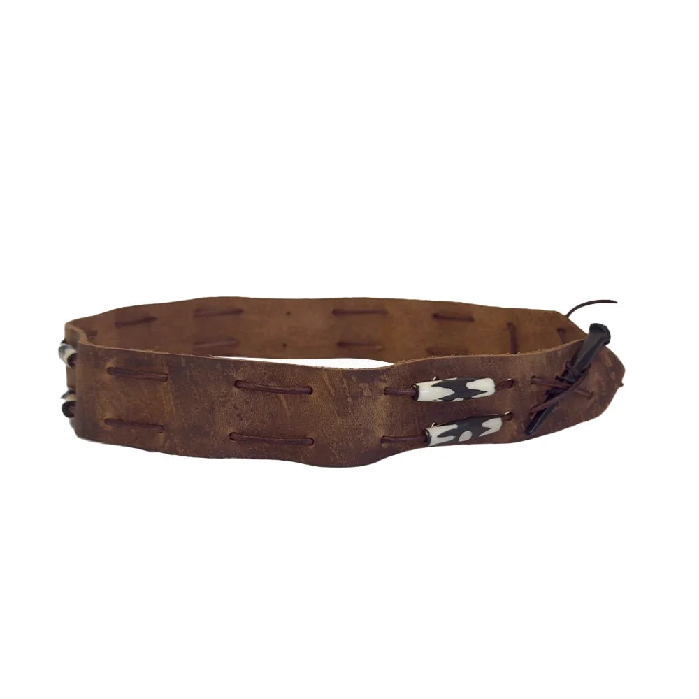 A brown leather bracelet with horizontal stitched details and small white and black decorative accents on the front, shown against a plain white background.