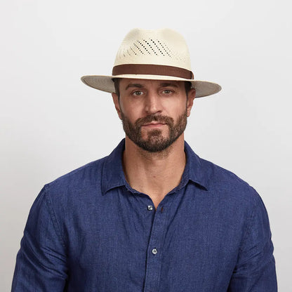 A man wearing a blue polo and the Tulum Straw Sun Hat