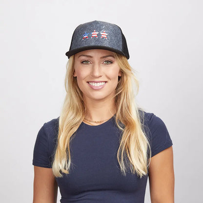 A blonde woman wearing a blue shirt and a black poly cap