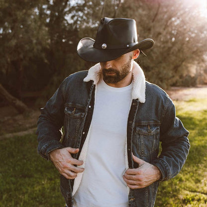 A man in denim jacket wearing a Black Leather Cowboy Hat 