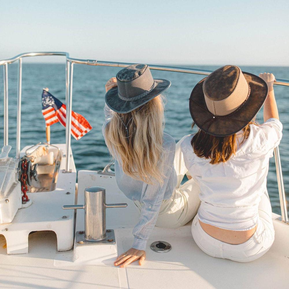 Two woman enjoying on a boat with an ocean view